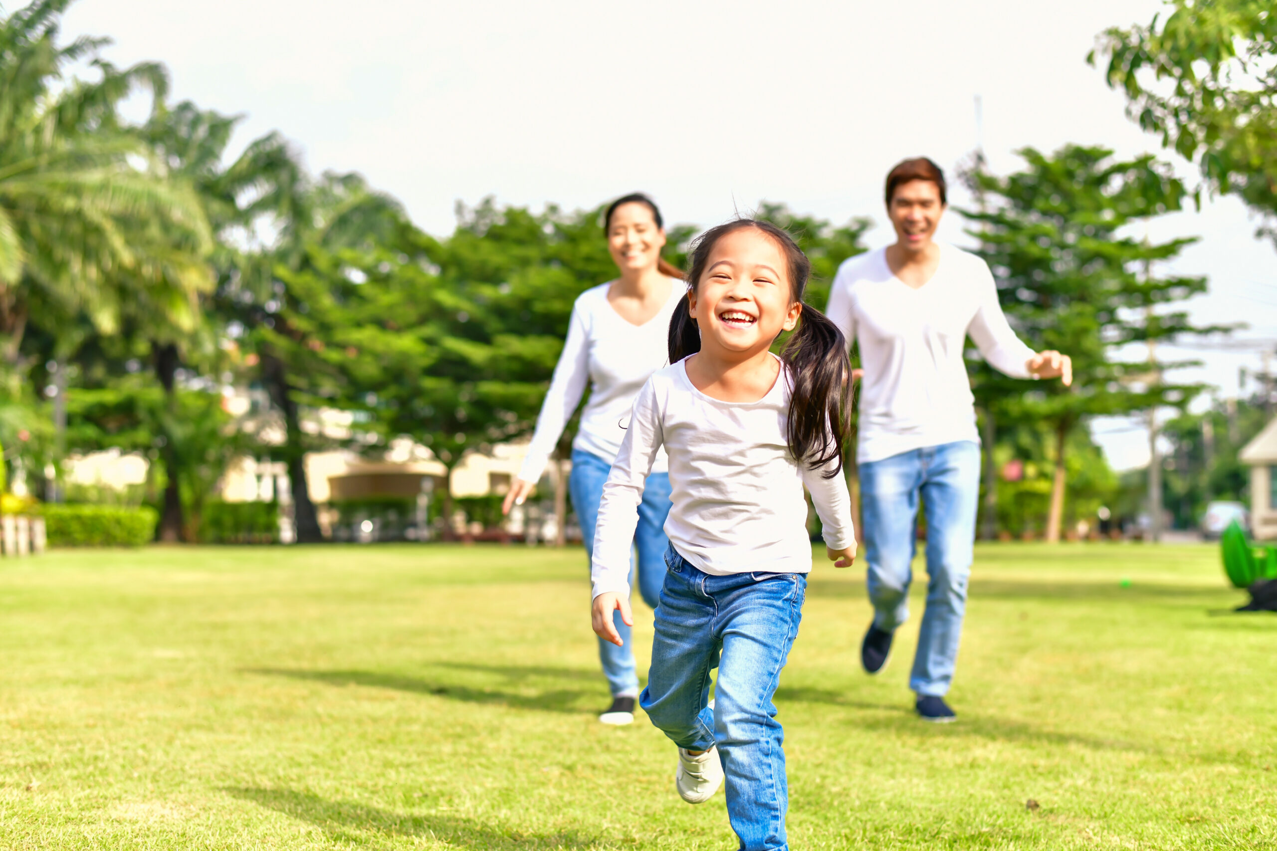 Parents and daughters go for a walk in the park.