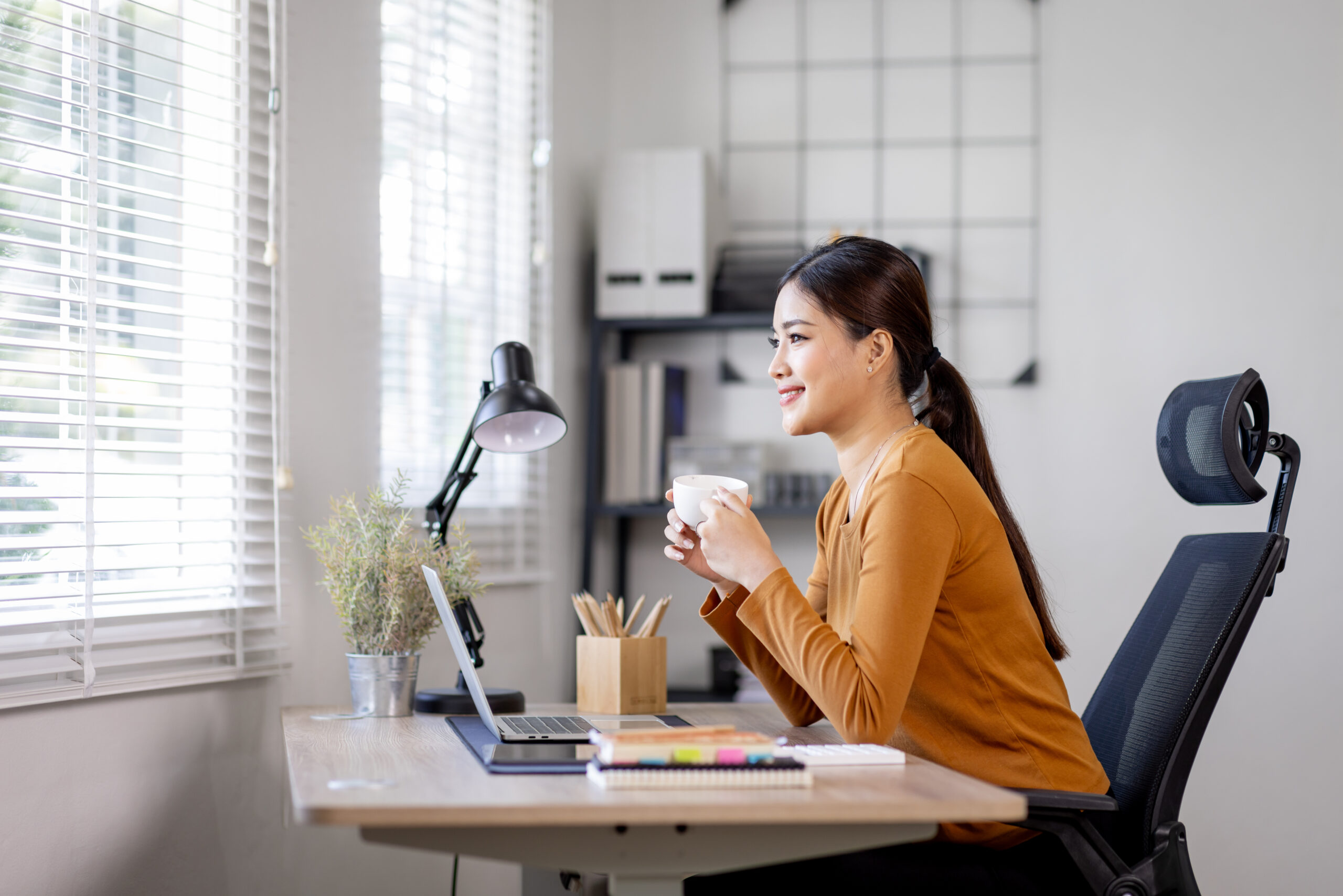 Young business asian woman work on laptop desk doing math finance on an office desk, tax, report, accounting, statistics, and analytical research concept